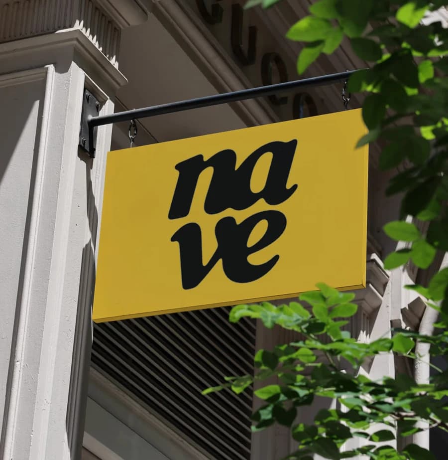 The nave sign hanging over the street, in leaf shade