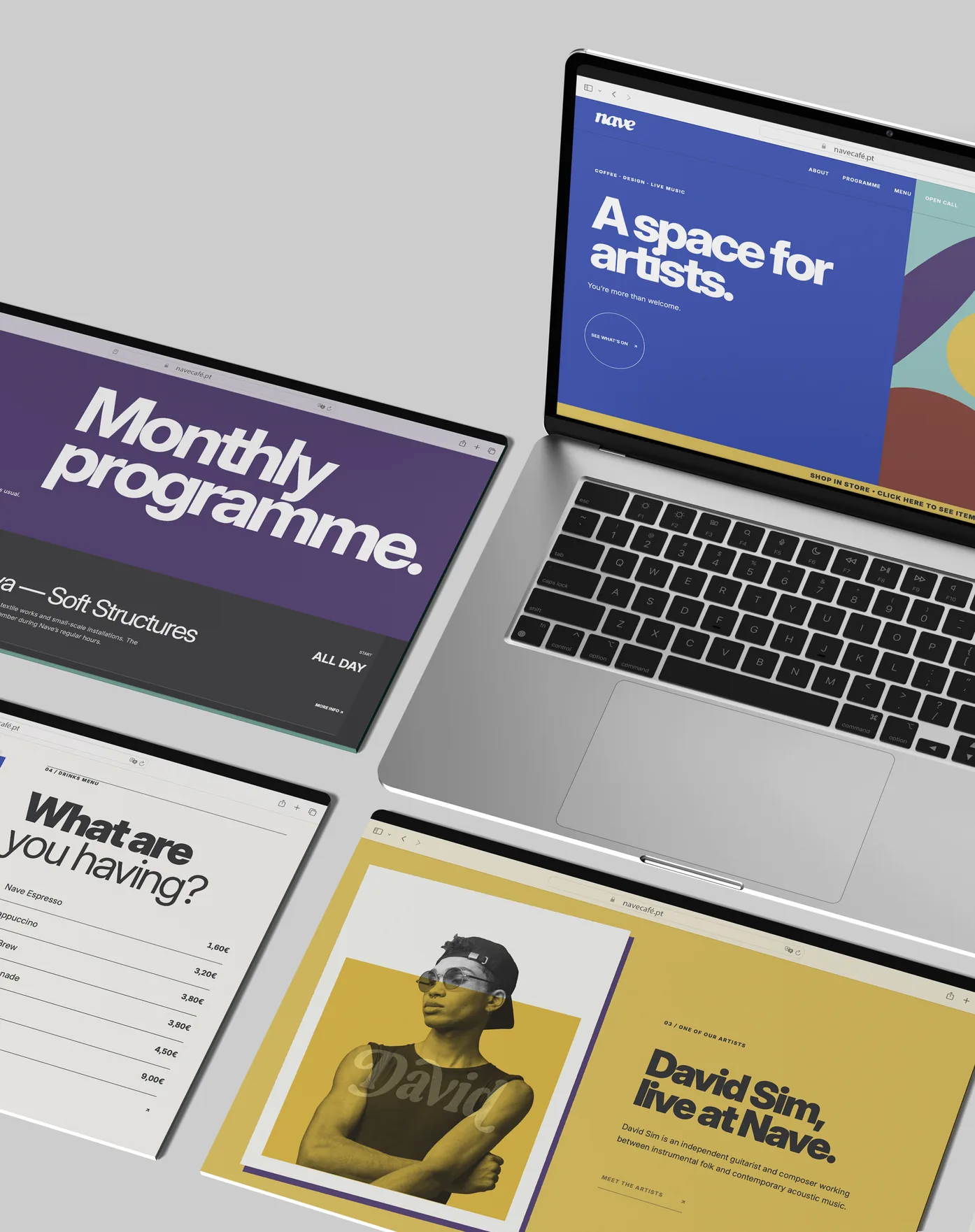 The site's pages laid out around a laptop, on grey